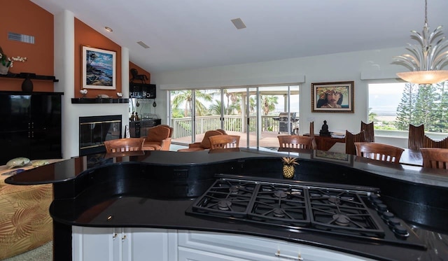 kitchen with lofted ceiling and white cabinetry