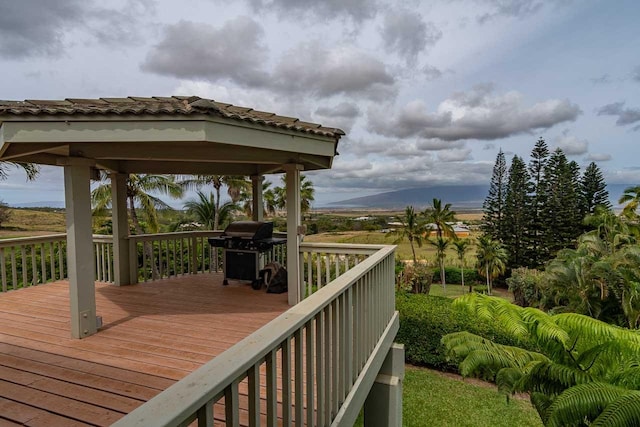 wooden deck featuring a grill and a gazebo