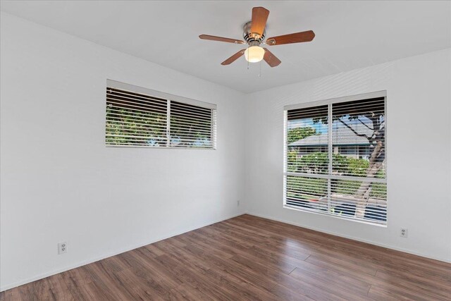 unfurnished living room featuring hardwood / wood-style floors, a wall unit AC, ceiling fan, and sink