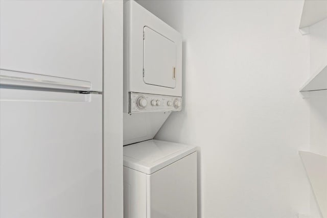 laundry room with stacked washer and dryer