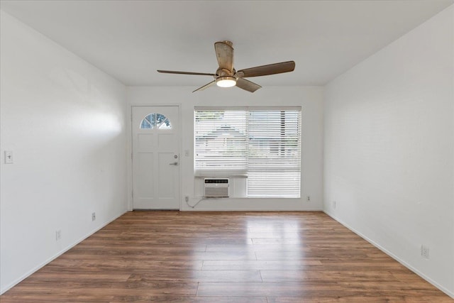 foyer entrance featuring wood-type flooring, a wall unit AC, ceiling fan, and cooling unit