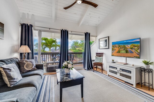 living room featuring wood ceiling, light wood-type flooring, high vaulted ceiling, ceiling fan, and beam ceiling