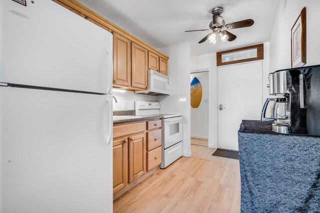 kitchen featuring ceiling fan, white appliances, light wood-type flooring, and light brown cabinets