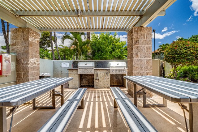 view of patio with grilling area, a pergola, and area for grilling