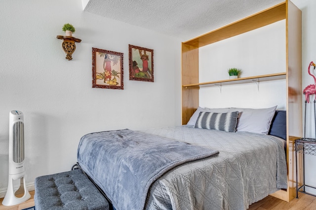 bedroom featuring a textured ceiling and light wood-type flooring