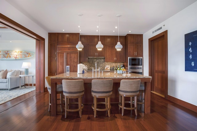 1 Bay Dr Unit 1205, Lahaina, HI 96761 - kitchen featuring built in appliances, backsplash, a sink, dark wood-style flooring, and baseboards