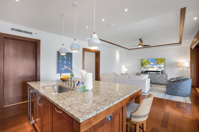 1 Bay Dr Unit 1205, Lahaina, HI 96761 - kitchen featuring a sink, wood finished floors, ceiling fan, a center island with sink, and light stone countertops