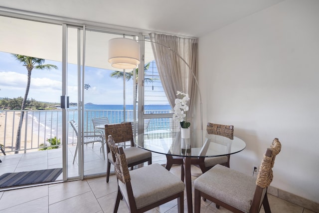 2450 S Kihei Rd Unit 506, Kihei, HI 96753 - dining area featuring expansive windows, a water view, and light tile patterned flooring