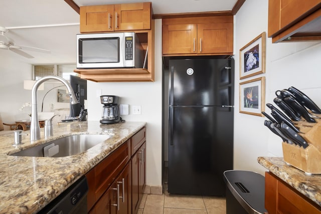2450 S Kihei Rd Unit 506, Kihei, HI 96753 - kitchen featuring black appliances, a sink, ceiling fan, brown cabinetry, and light stone countertops