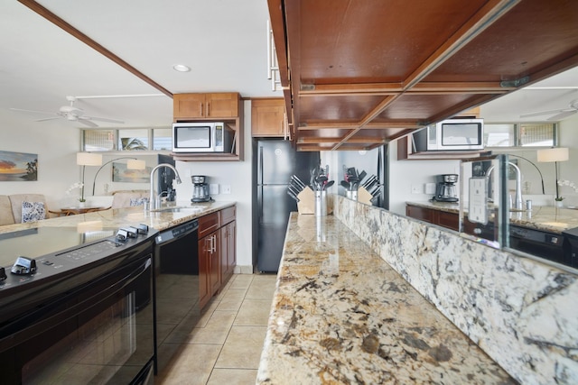 2450 S Kihei Rd Unit 506, Kihei, HI 96753 - kitchen featuring a sink, black appliances, a ceiling fan, and light stone counters