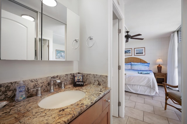 2450 S Kihei Rd Unit 506, Kihei, HI 96753 - ensuite bathroom with tile patterned floors, vanity, tile walls, and a ceiling fan