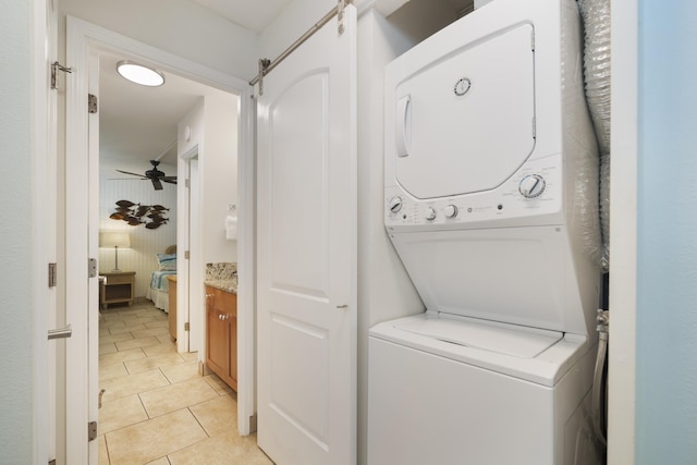 2450 S Kihei Rd Unit 506, Kihei, HI 96753 - laundry area featuring estacked washer and dryer, light tile patterned flooring, and ceiling fan