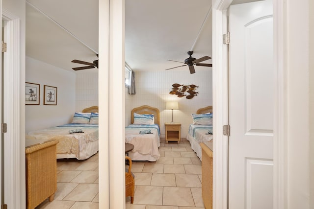 2450 S Kihei Rd Unit 506, Kihei, HI 96753 - bedroom with tile walls, light tile patterned flooring, and a ceiling fan