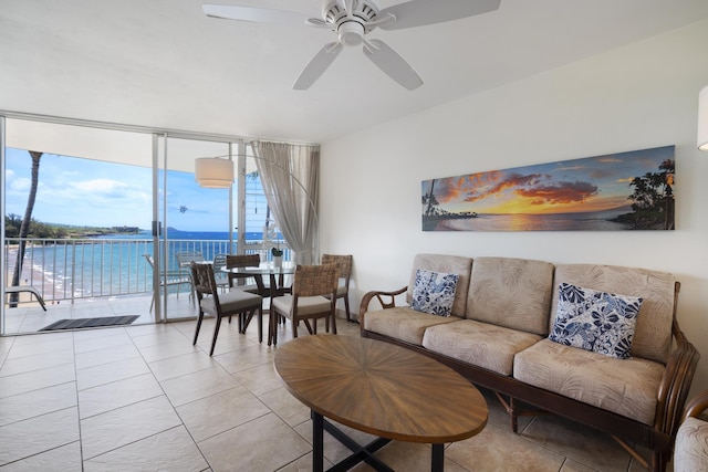 2450 S Kihei Rd Unit 506, Kihei, HI 96753 - living room featuring expansive windows, ceiling fan, light tile patterned flooring, and a water view