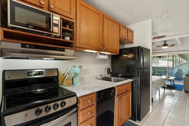 715 S Kihei Rd Unit D135, Kihei, HI 96753 - kitchen with black appliances, a sink, light countertops, light tile patterned flooring, and under cabinet range hood