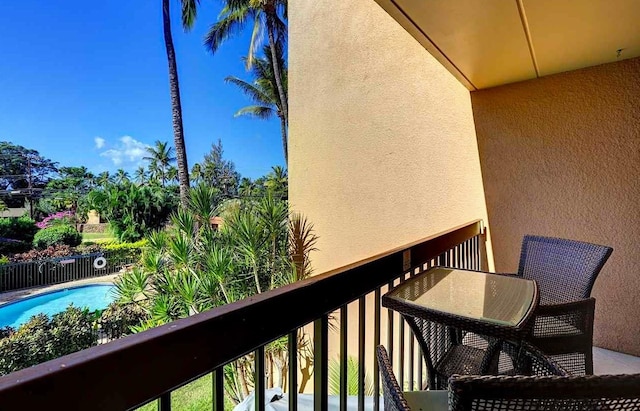 balcony featuring a community pool