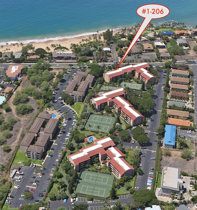 drone / aerial view with a beach view and a water view