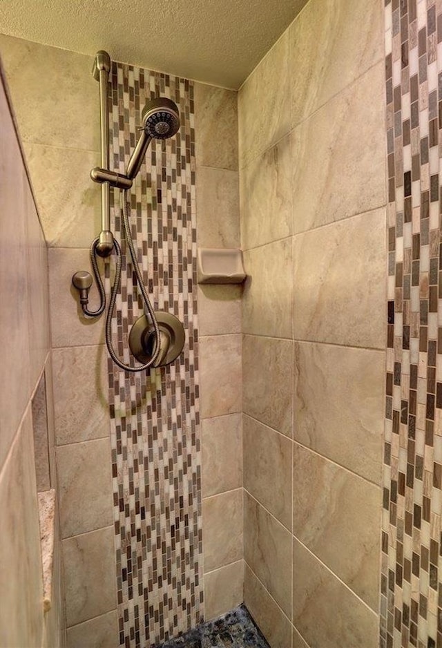 bathroom with tiled shower