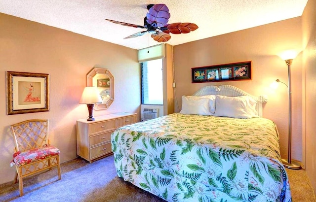 bedroom featuring a textured ceiling, dark colored carpet, and ceiling fan