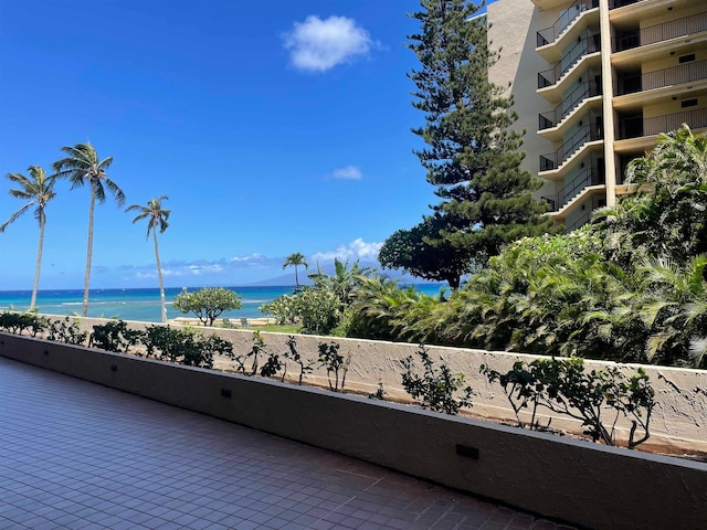 balcony featuring a water view and a beach view