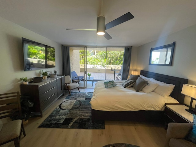 bedroom with light hardwood / wood-style flooring, ceiling fan, a wall of windows, and access to exterior