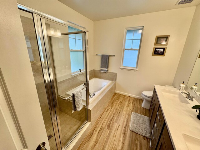 24 Kupaloke St, Wailuku, HI 96793 - bathroom featuring wood finished floors, double vanity, a garden tub, and healthy amount of natural light