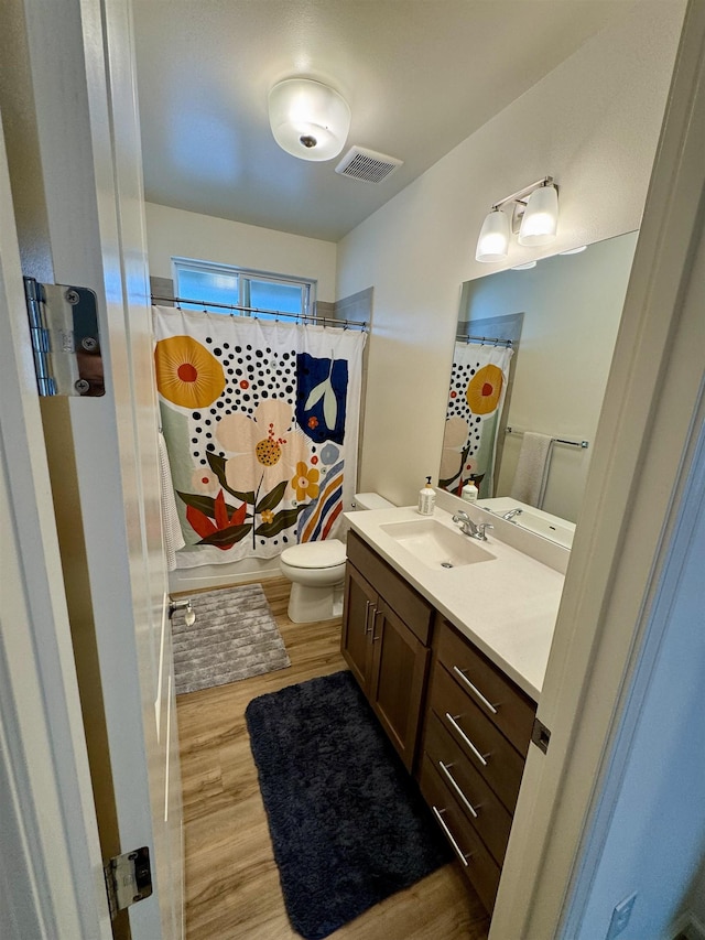 24 Kupaloke St, Wailuku, HI 96793 - bathroom featuring wood finished floors, vanity, toilet, and a shower with curtain