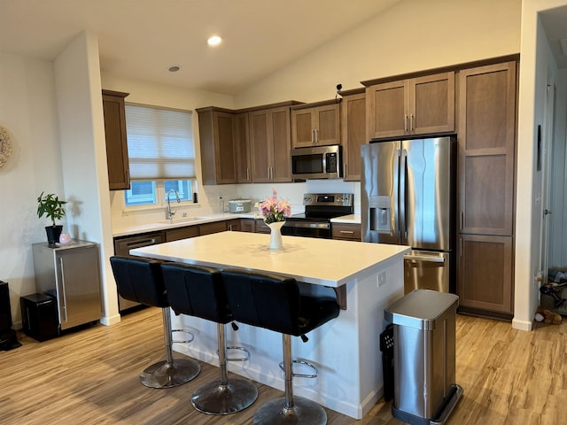24 Kupaloke St, Wailuku, HI 96793 - kitchen featuring stainless steel appliances, a sink, a center island, light countertops, and light wood-type flooring