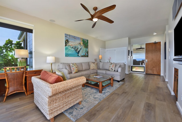 living room featuring light wood-type flooring and ceiling fan