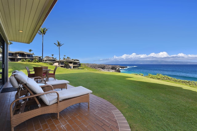 view of yard with a patio area and a water view