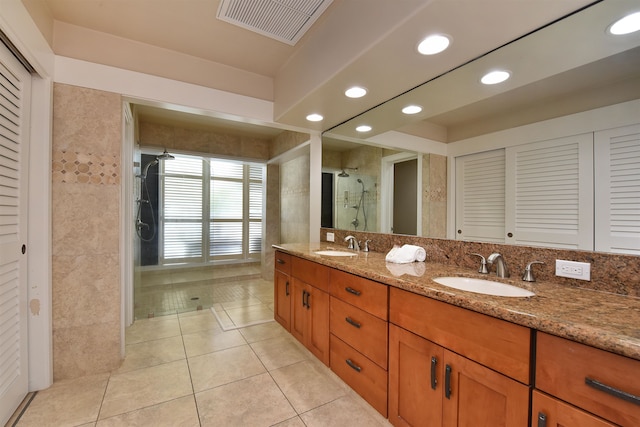 bathroom with vanity, tile patterned floors, and tiled shower