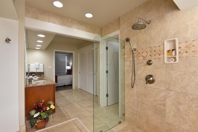 bathroom with vanity, tile patterned floors, and a tile shower