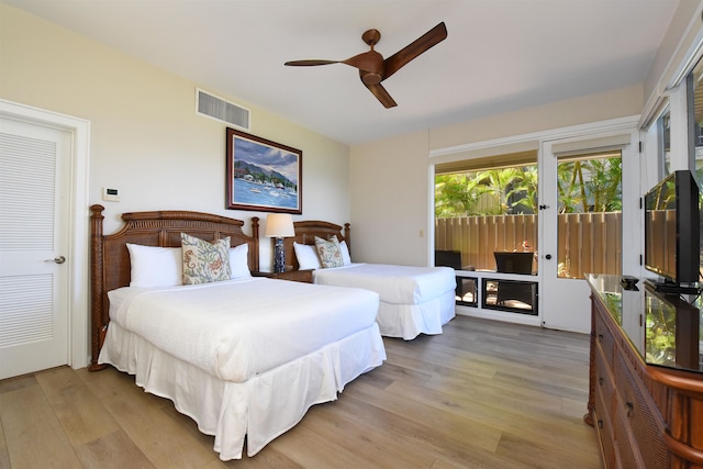 bedroom featuring access to outside, light wood-type flooring, and ceiling fan