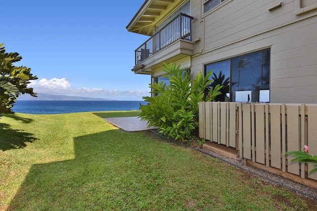 view of yard featuring a balcony and a water view