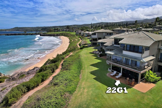 birds eye view of property with a water view and a beach view