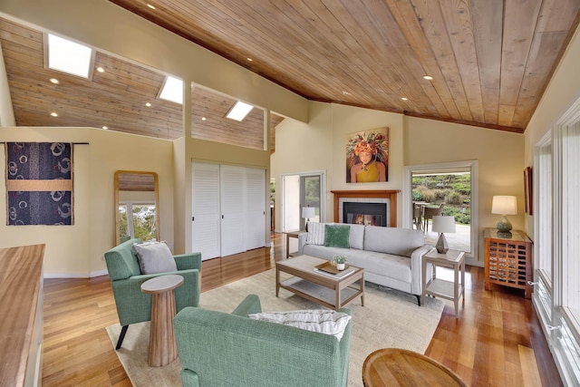 living area with wooden ceiling, a fireplace, high vaulted ceiling, and light wood finished floors