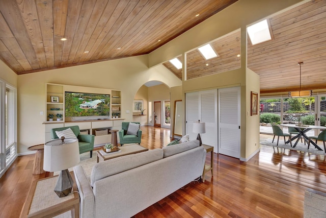 living room featuring light wood-type flooring, wooden ceiling, and arched walkways