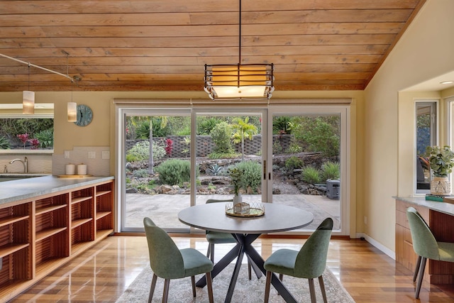 dining room with wood ceiling, baseboards, vaulted ceiling, and a wealth of natural light