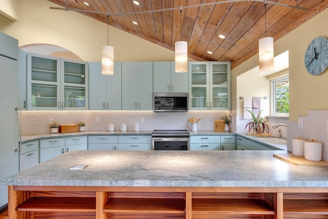 kitchen featuring wood ceiling, glass insert cabinets, appliances with stainless steel finishes, decorative light fixtures, and a sink