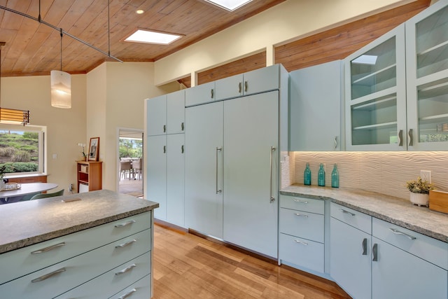 kitchen with wooden ceiling, glass insert cabinets, and pendant lighting