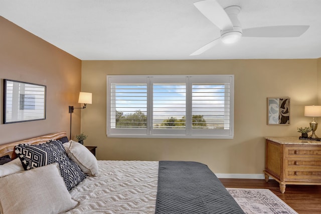 bedroom featuring dark wood-style floors, ceiling fan, and baseboards