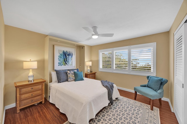 bedroom with a ceiling fan, a closet, baseboards, and wood finished floors