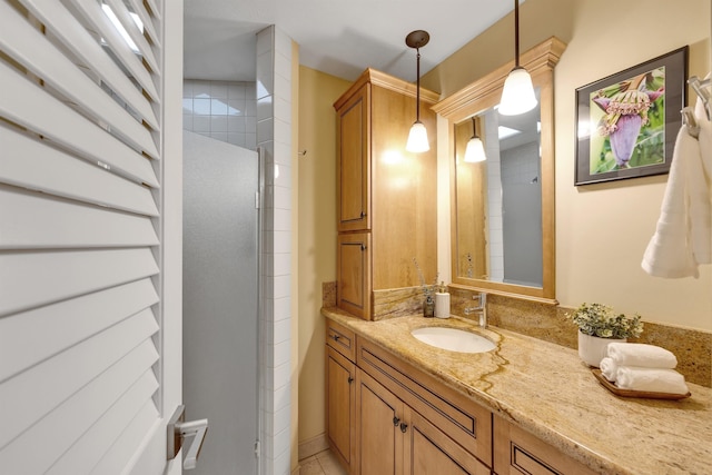 bathroom with vanity and a shower with shower door