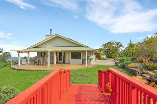 rear view of property with a patio and a yard