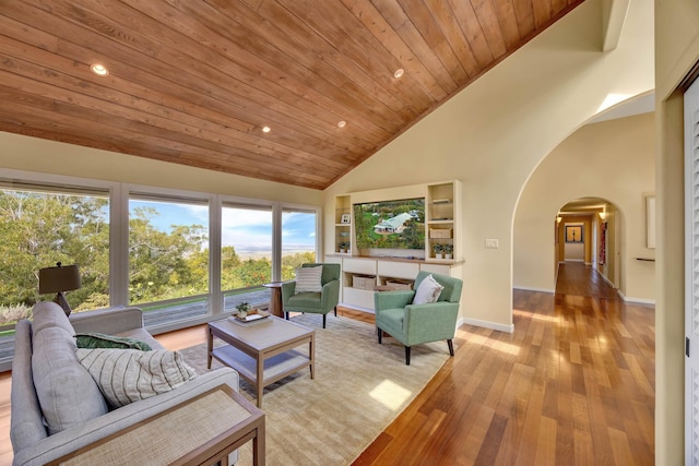 living room with arched walkways, wood ceiling, light wood-type flooring, high vaulted ceiling, and recessed lighting