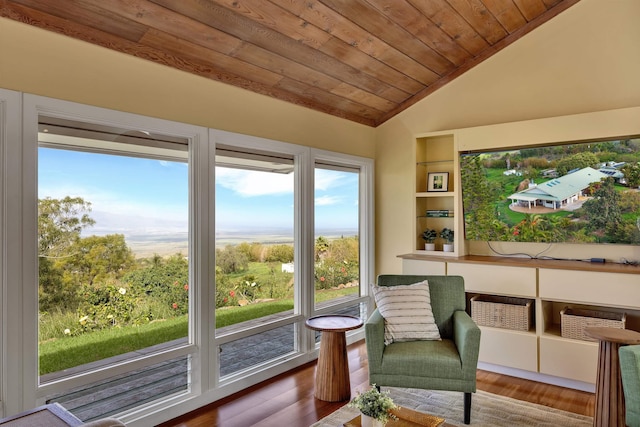 living area featuring wooden ceiling, vaulted ceiling, and wood finished floors