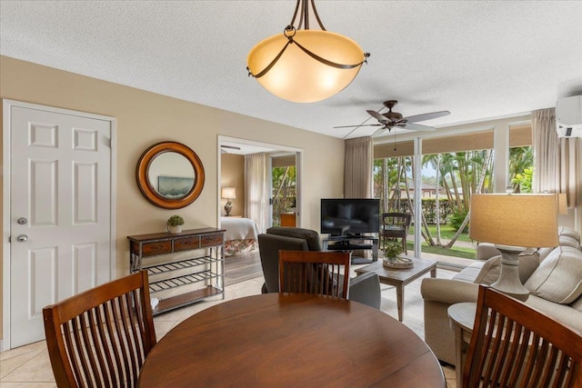 tiled dining room featuring ceiling fan and a textured ceiling