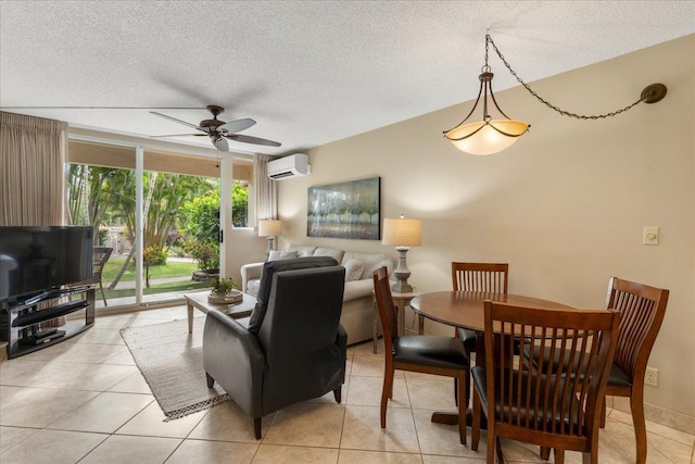 living room featuring ceiling fan, light tile patterned flooring, an AC wall unit, and a textured ceiling