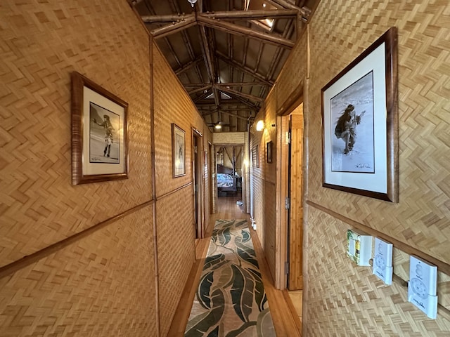 corridor featuring high vaulted ceiling and beamed ceiling