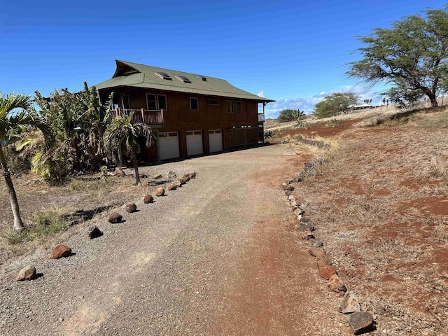 view of property exterior with driveway and a garage